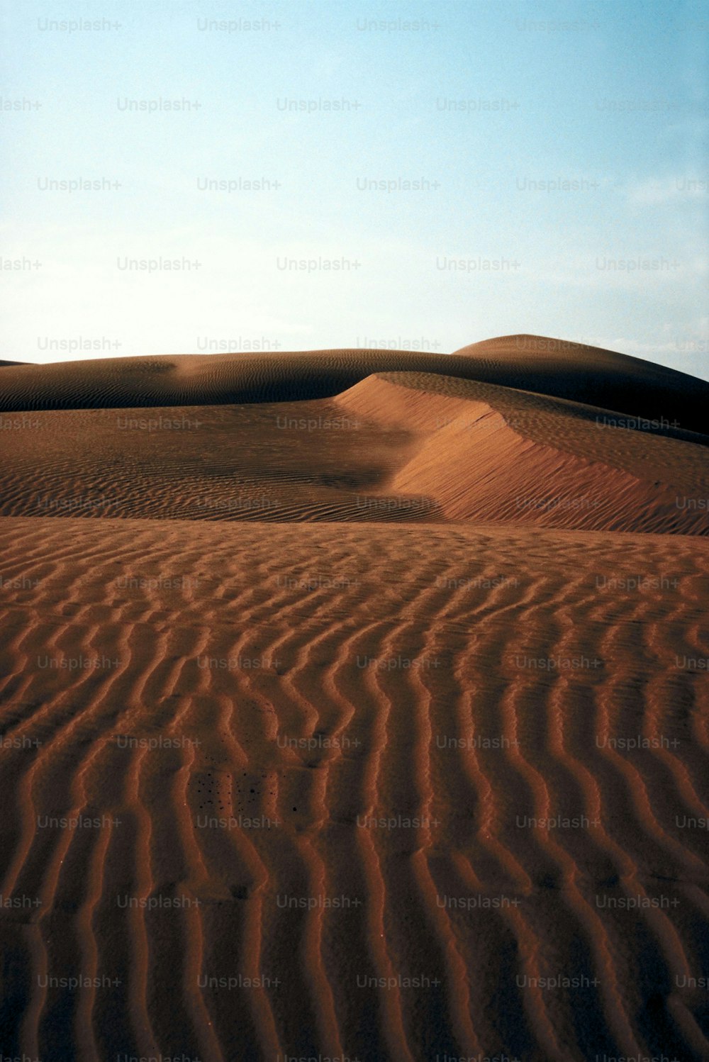 a desert landscape with a blue sky in the background
