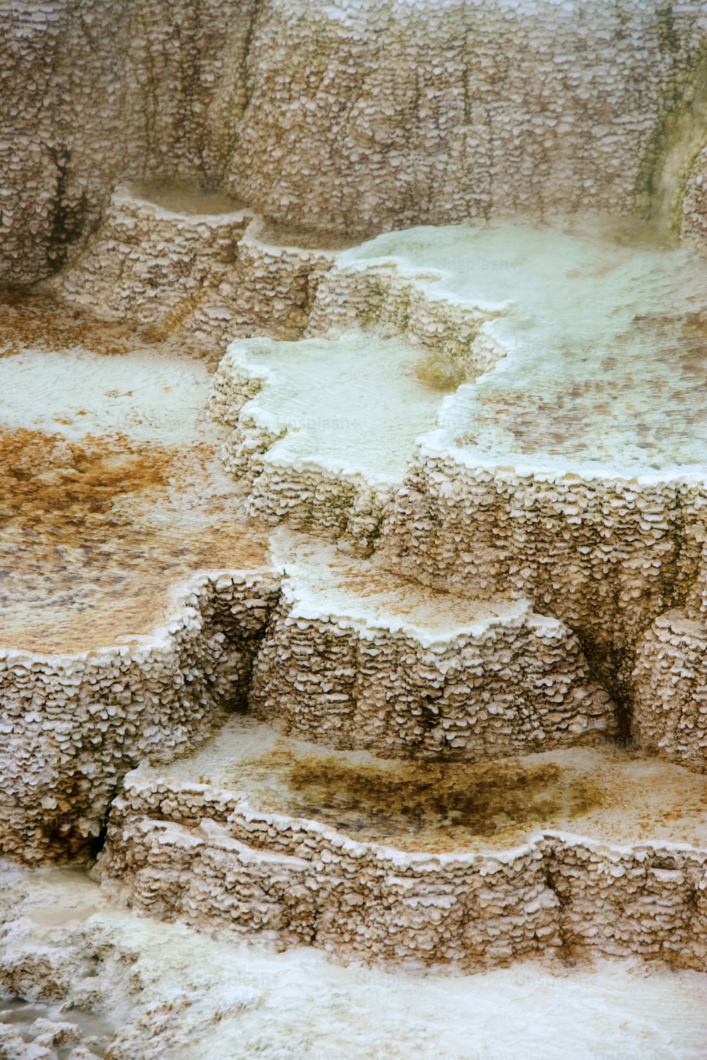a close up of a hot spring in a desert