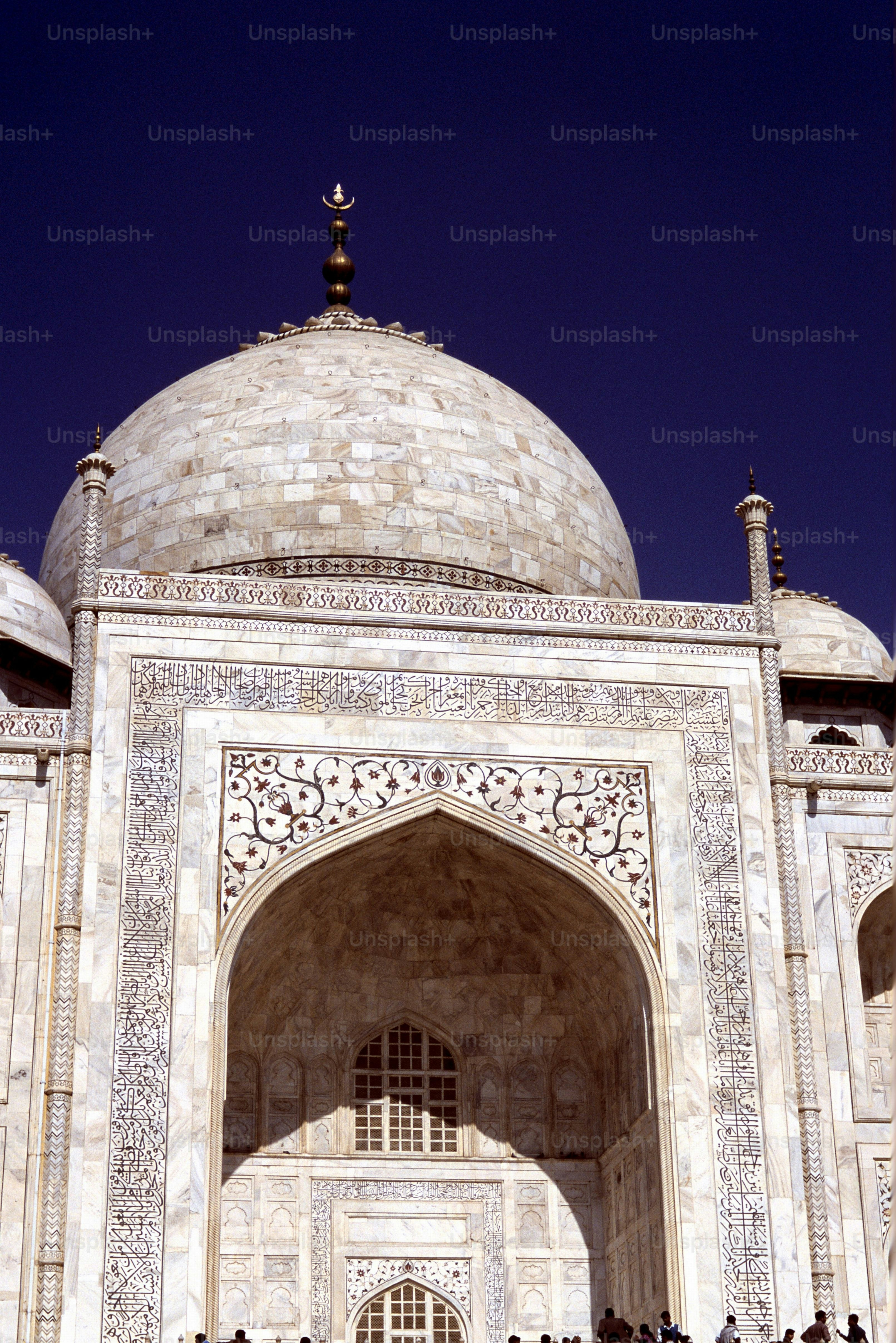 a group of people standing in front of a white building