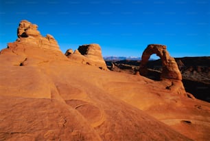 a large rock formation in the middle of a desert