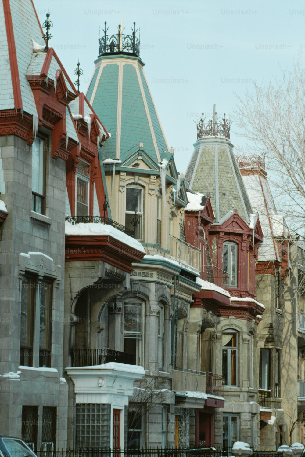 a row of houses with snow on the ground