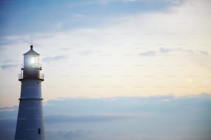 a white lighthouse with a light on top of it