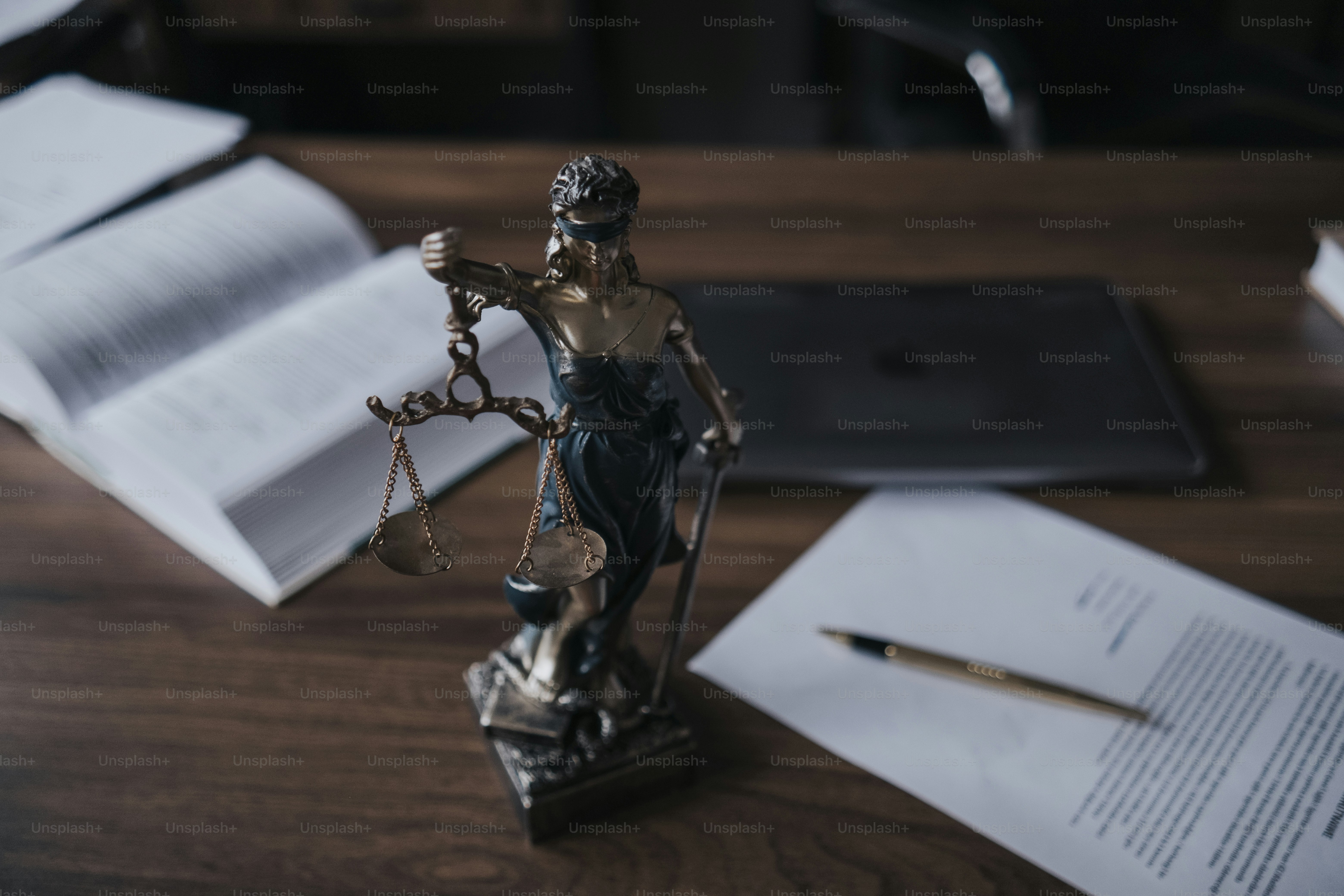 a statue of a lady justice holding a scale of justice