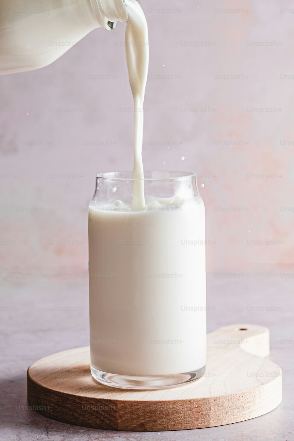 a glass of milk being poured into a glass