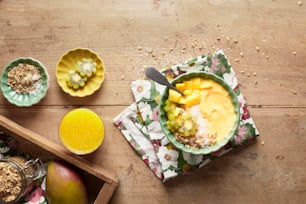 a wooden table topped with bowls of food