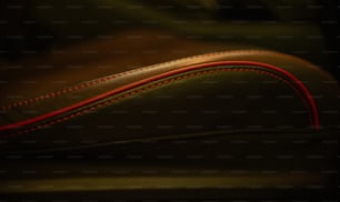 a close up of a leather seat with red stitching