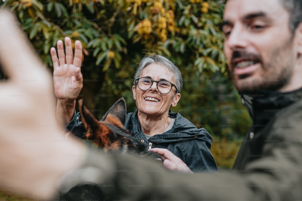 a man holding a dog up to a woman's hand