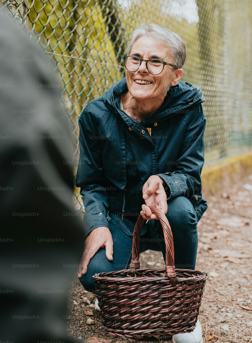 a man sitting on the ground holding a basket