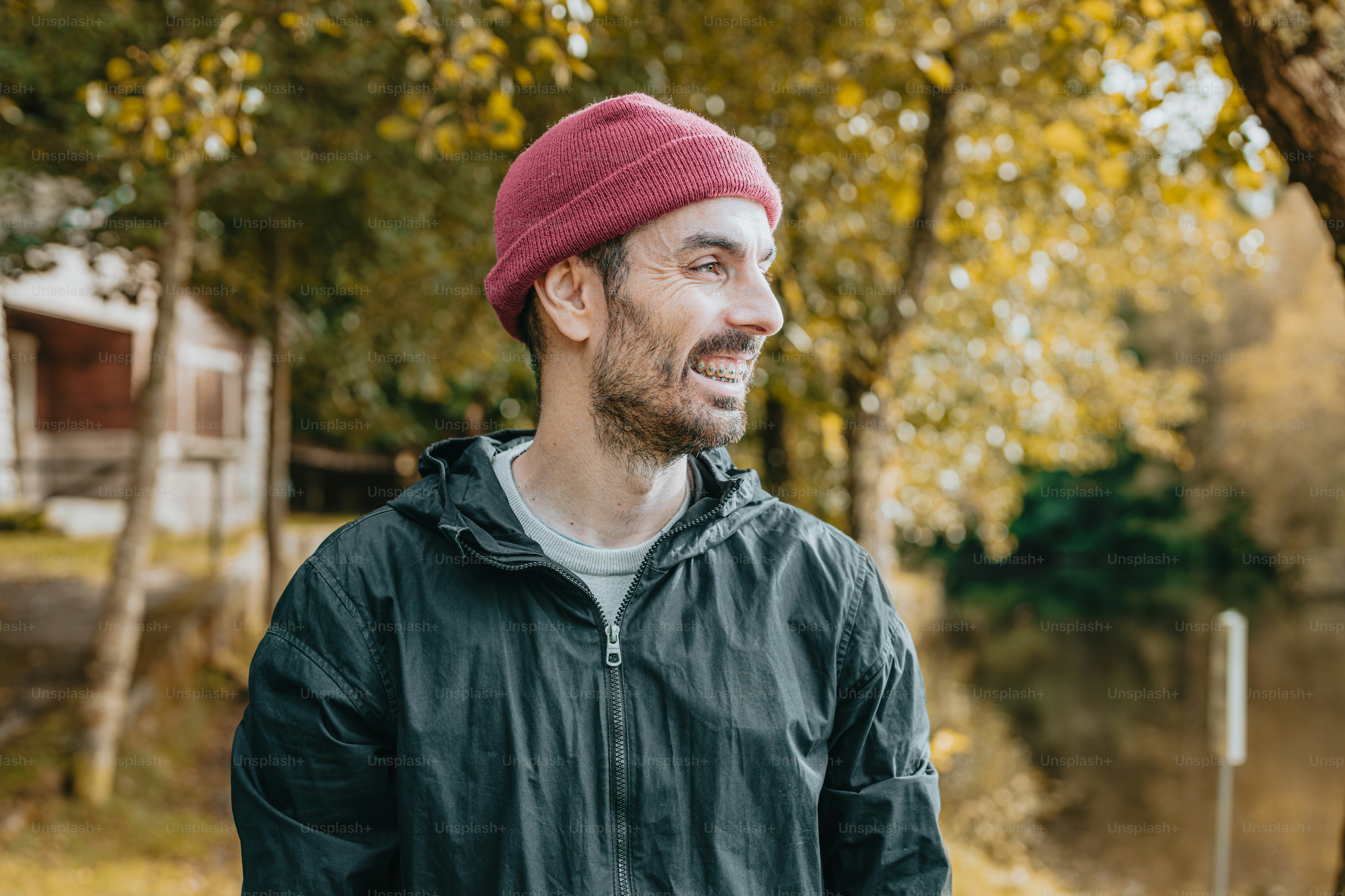 A man wearing a red hat standing in front of a tree photo – Nature ...