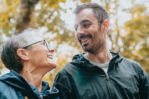 a man standing next to a woman in a park