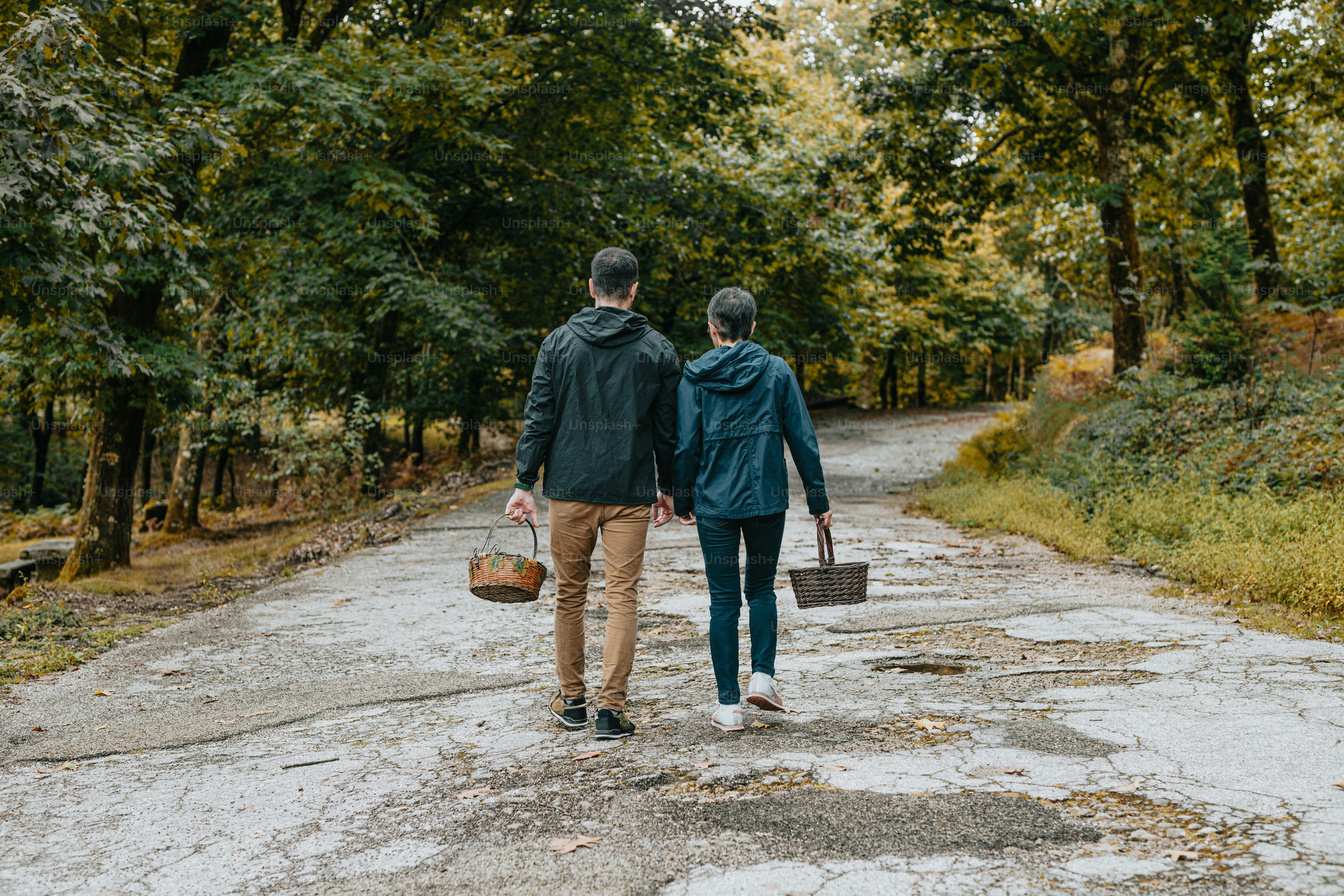a man and a woman walking down a dirt road