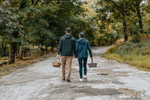 a man and a woman walking down a dirt road