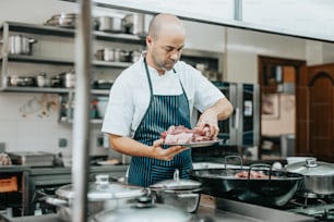 a man standing in a kitchen preparing food