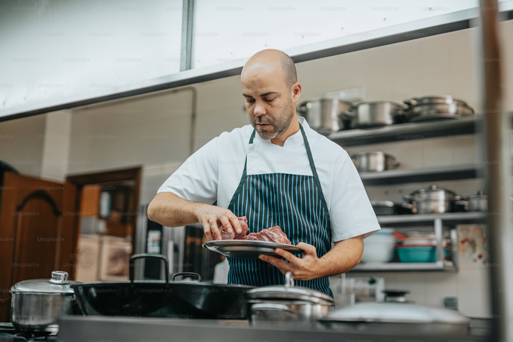 a man standing in a kitchen preparing food