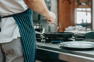 a man is cooking on a stove in a kitchen