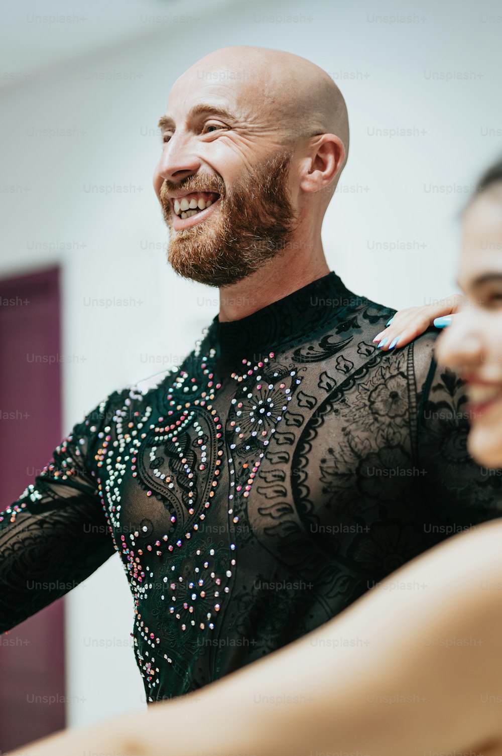 a man with a bald head is dancing with a woman