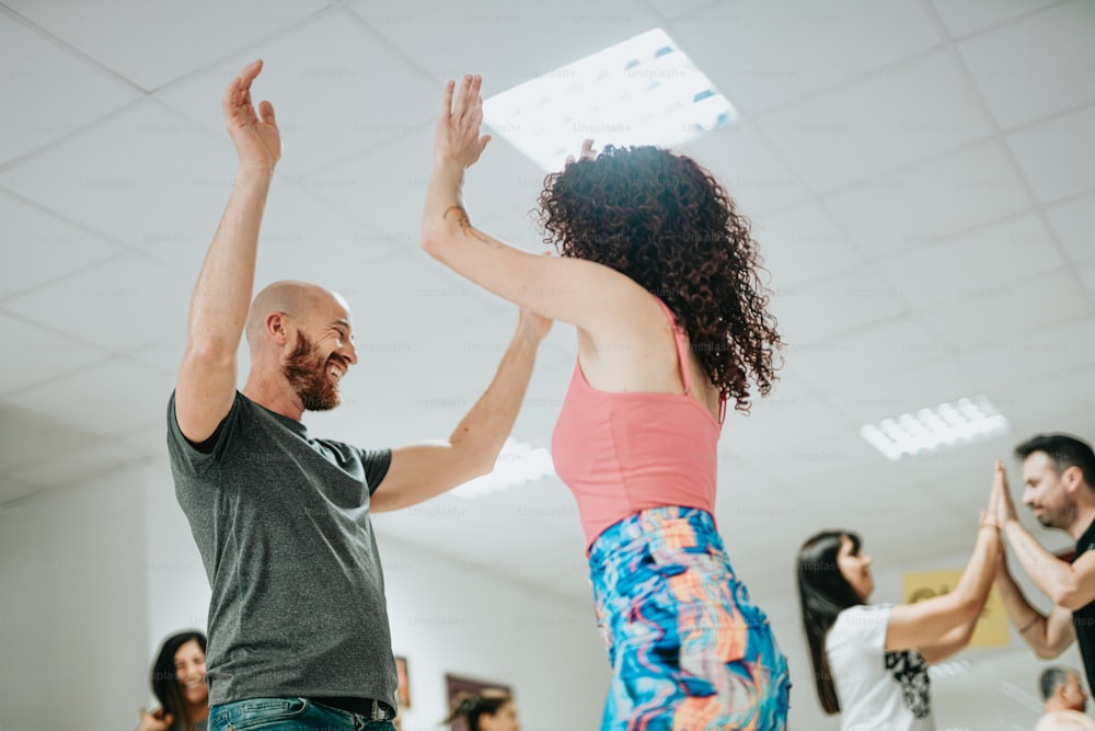 a man and woman dancing in a dance class