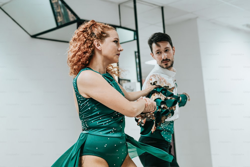 a man and a woman dancing in a dance studio