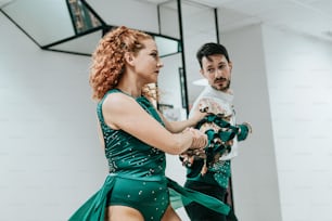 a man and a woman dancing in a dance studio