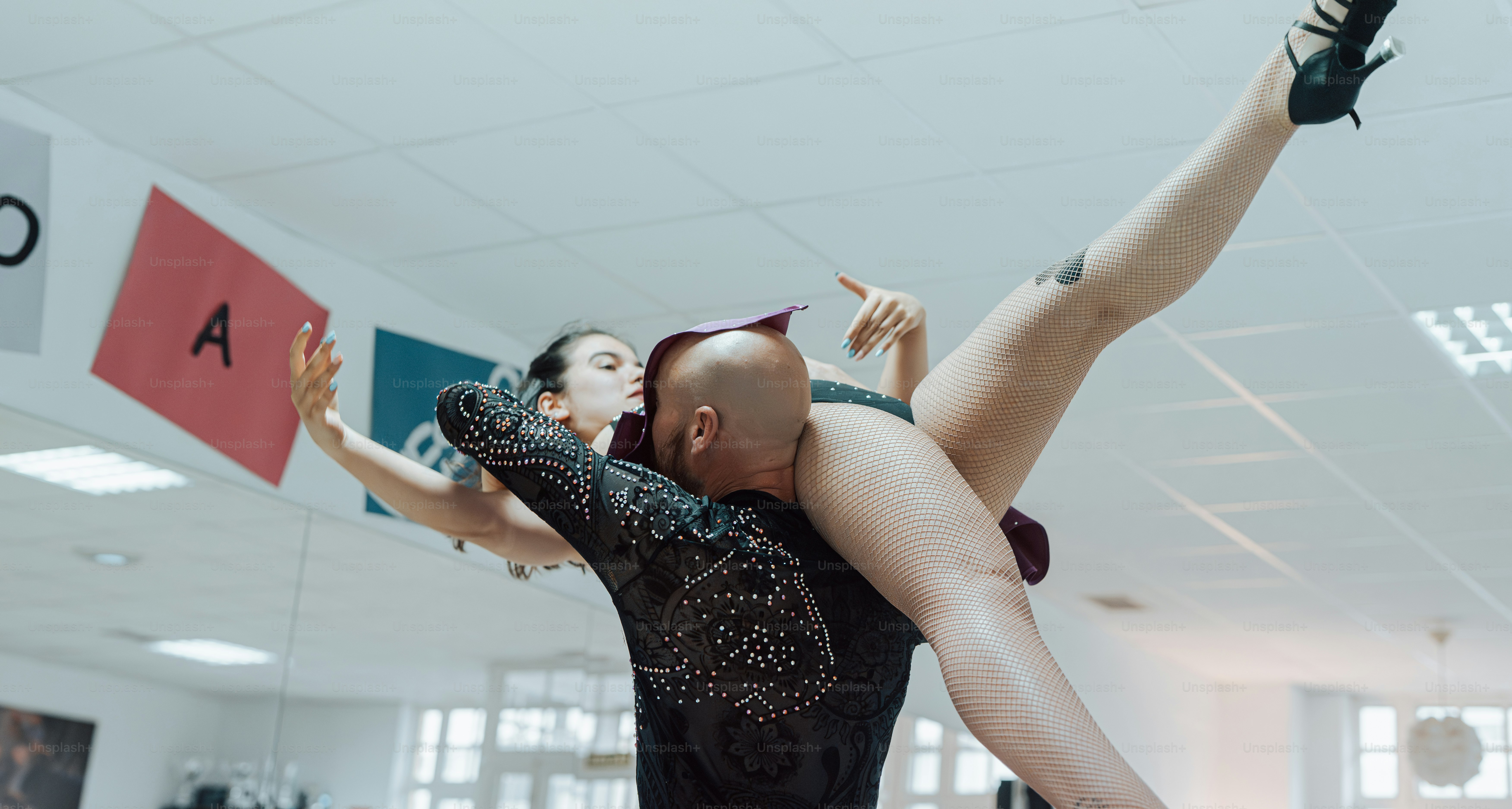 a man and a woman dance in a dance studio