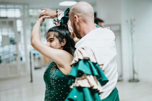 a man and a woman dance together in a dance studio