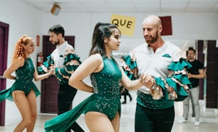 a man and a woman dancing in a dance studio