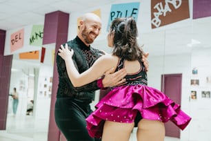 a man and a woman dancing in a dance studio