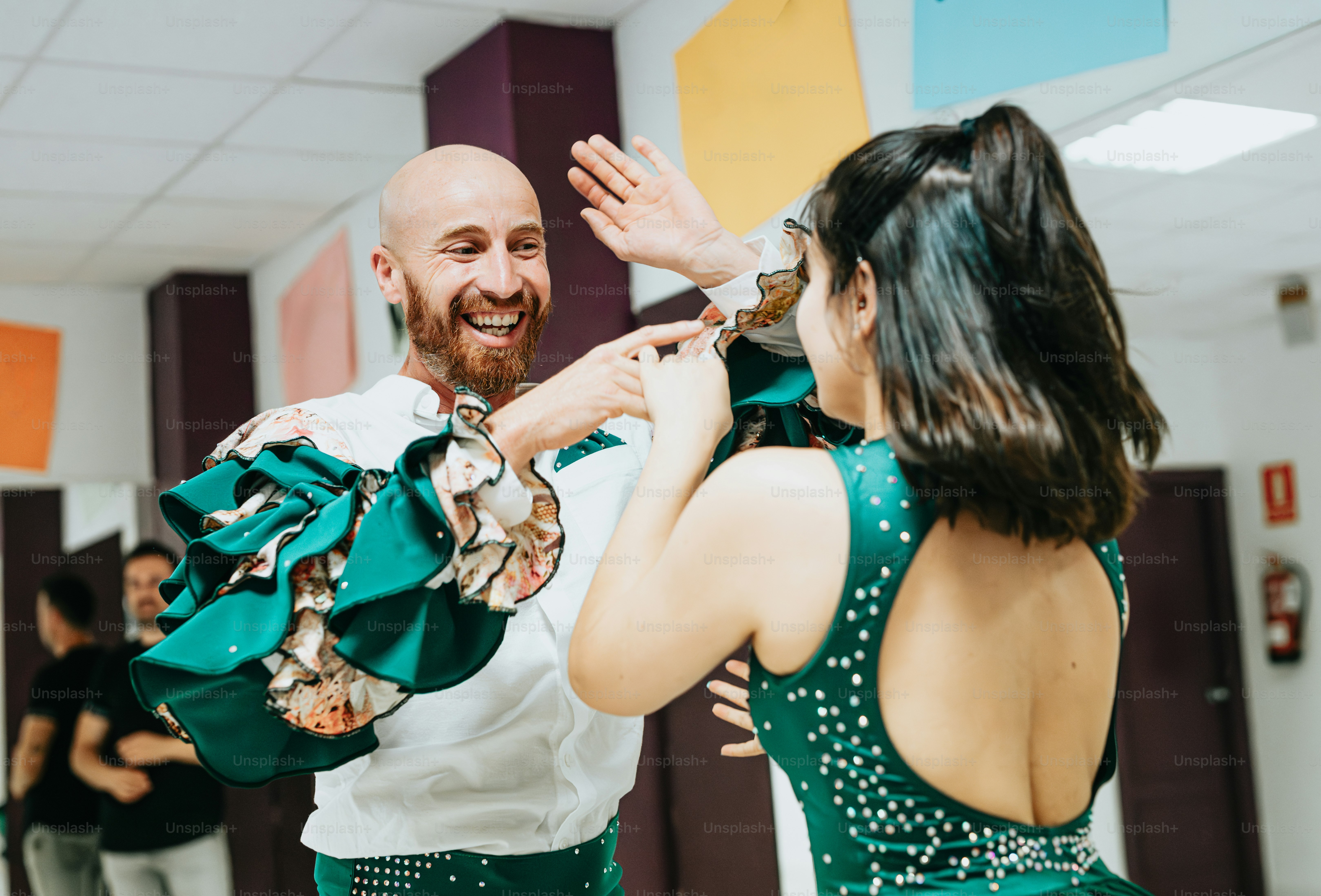 a man and woman dancing together in a room