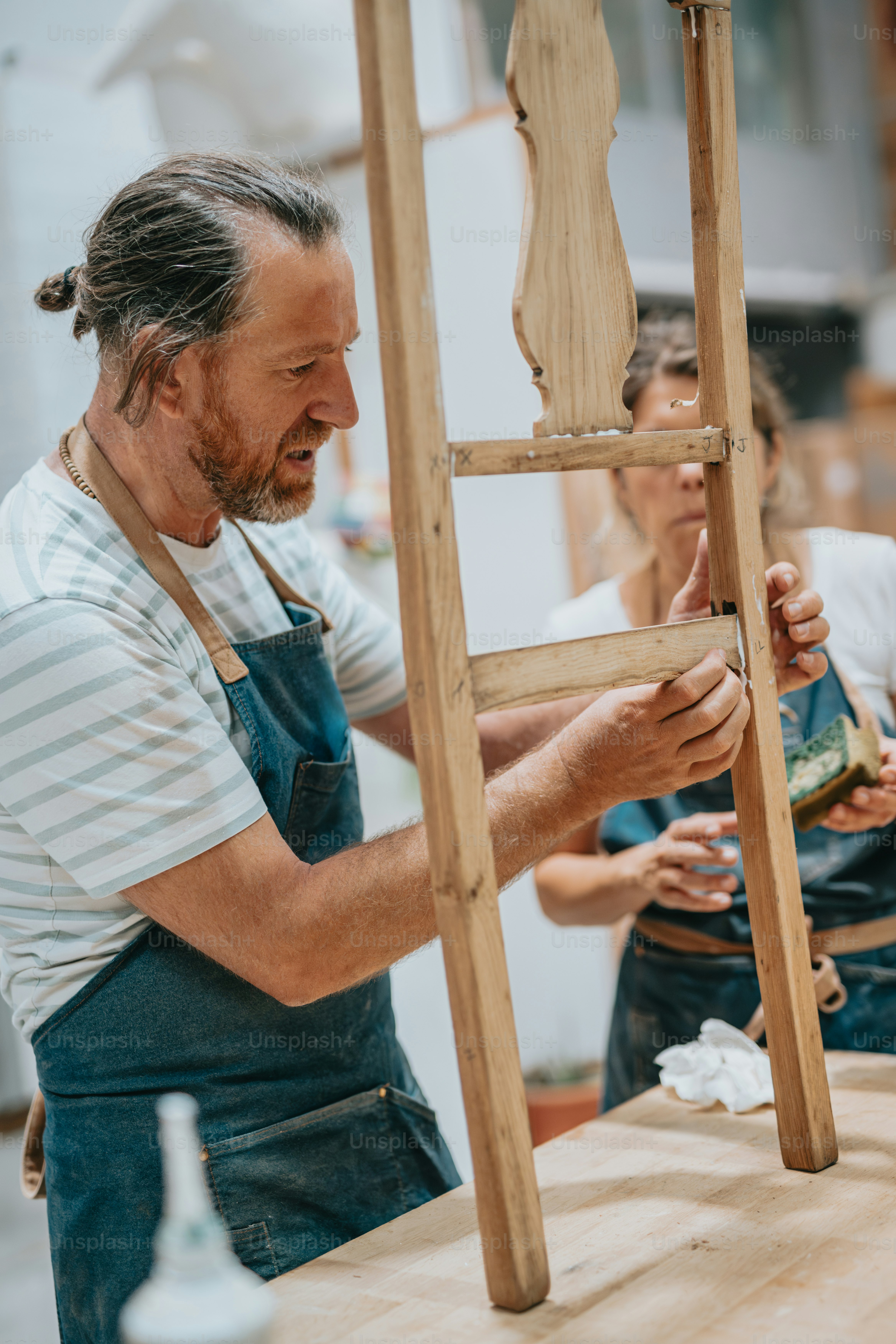 a man is working on a wooden ladder