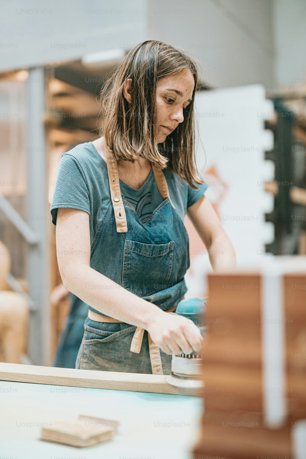 a woman working on a piece of wood