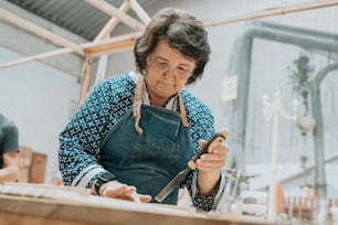a woman in an apron using a cell phone