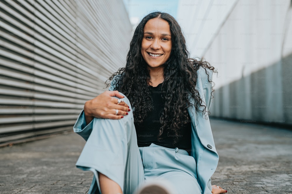 a woman sitting on the ground smiling