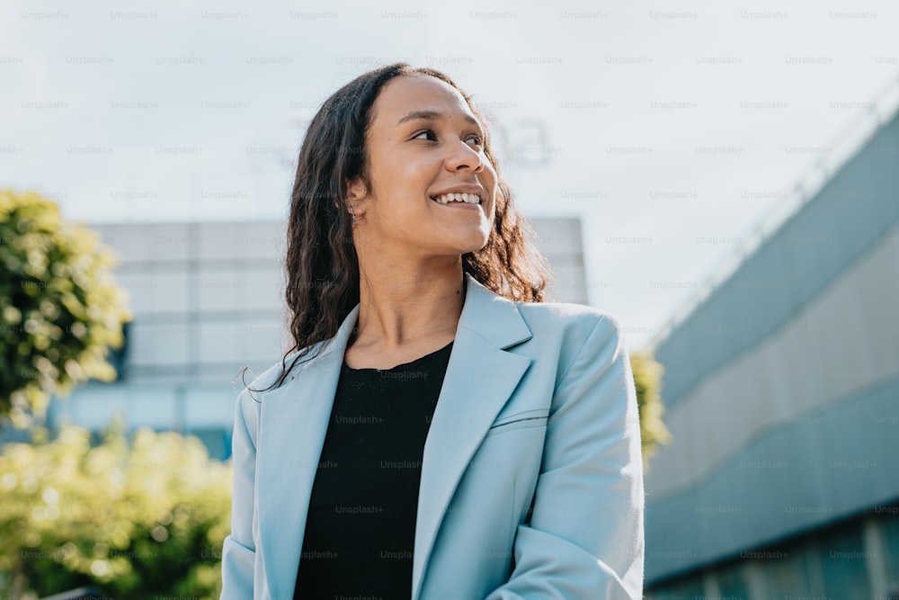 a woman in a blue blazer smiles at the camera