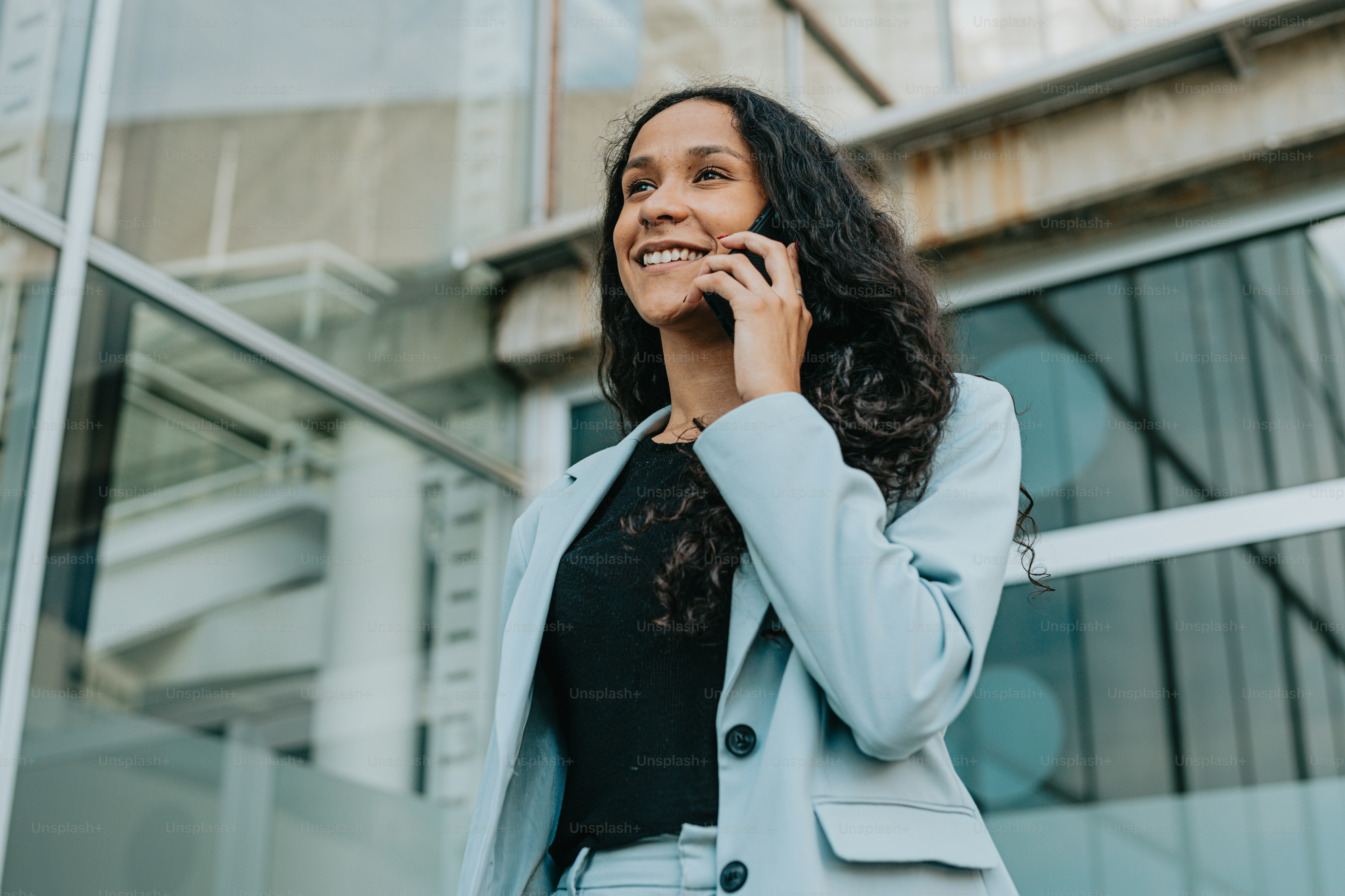 a woman talking on a cell phone in front of a building