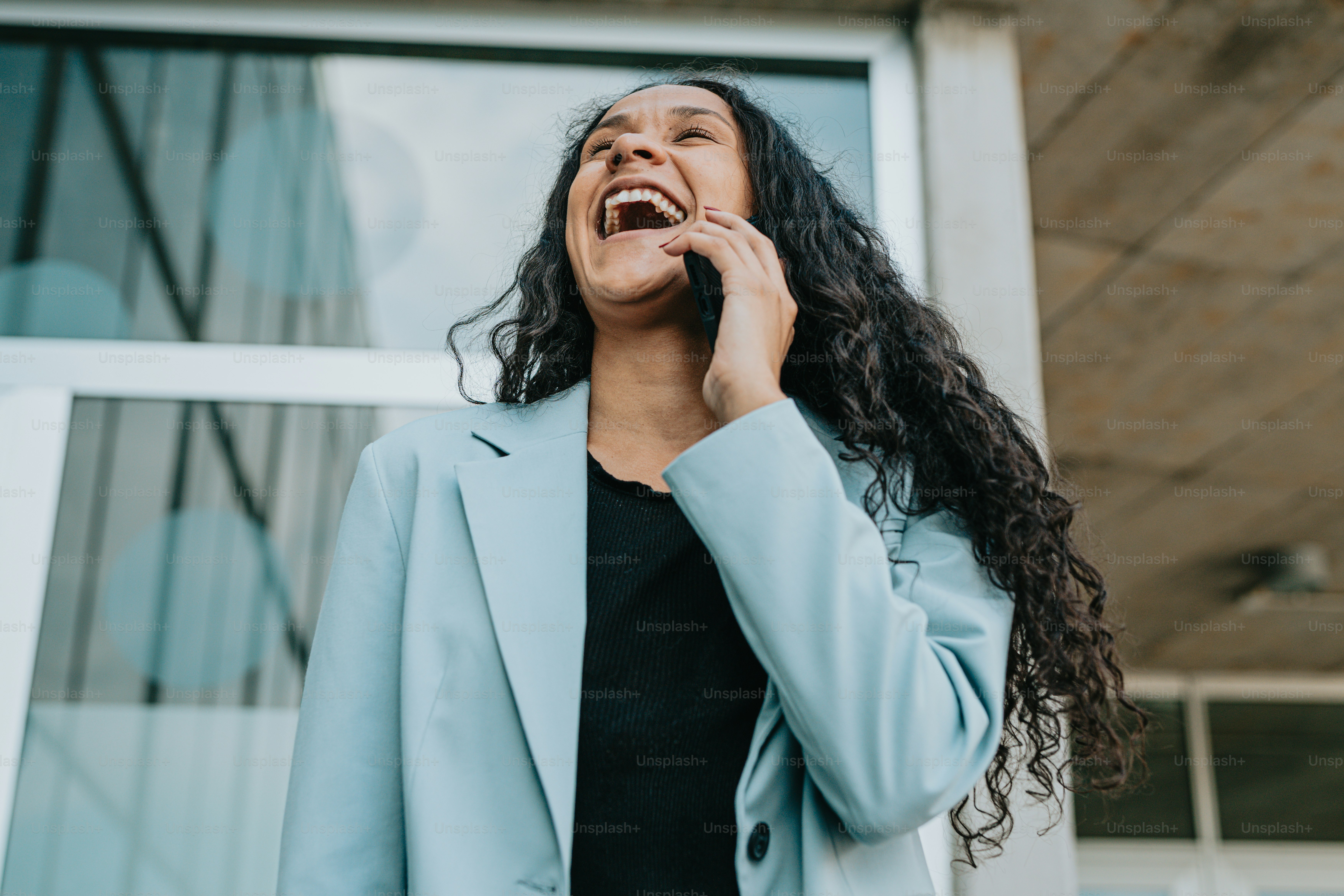 a woman talking on a cell phone outside of a building
