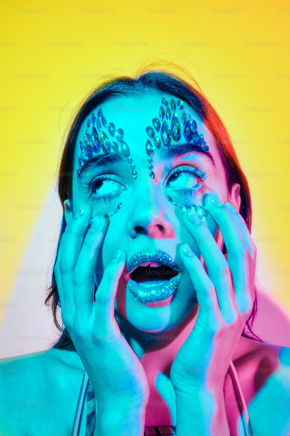 a woman with blue makeup and glitter on her face