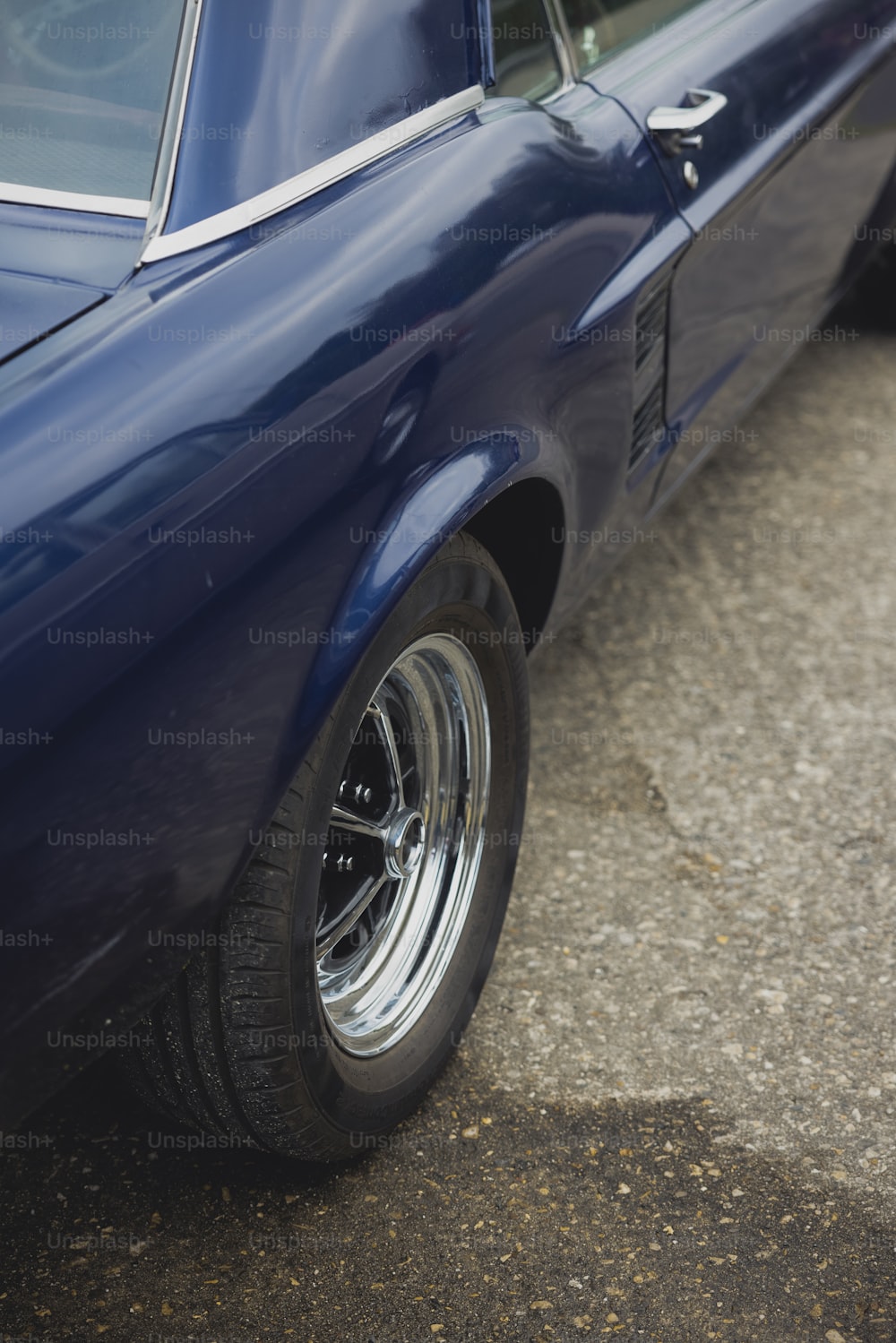 a blue car parked on the side of the road