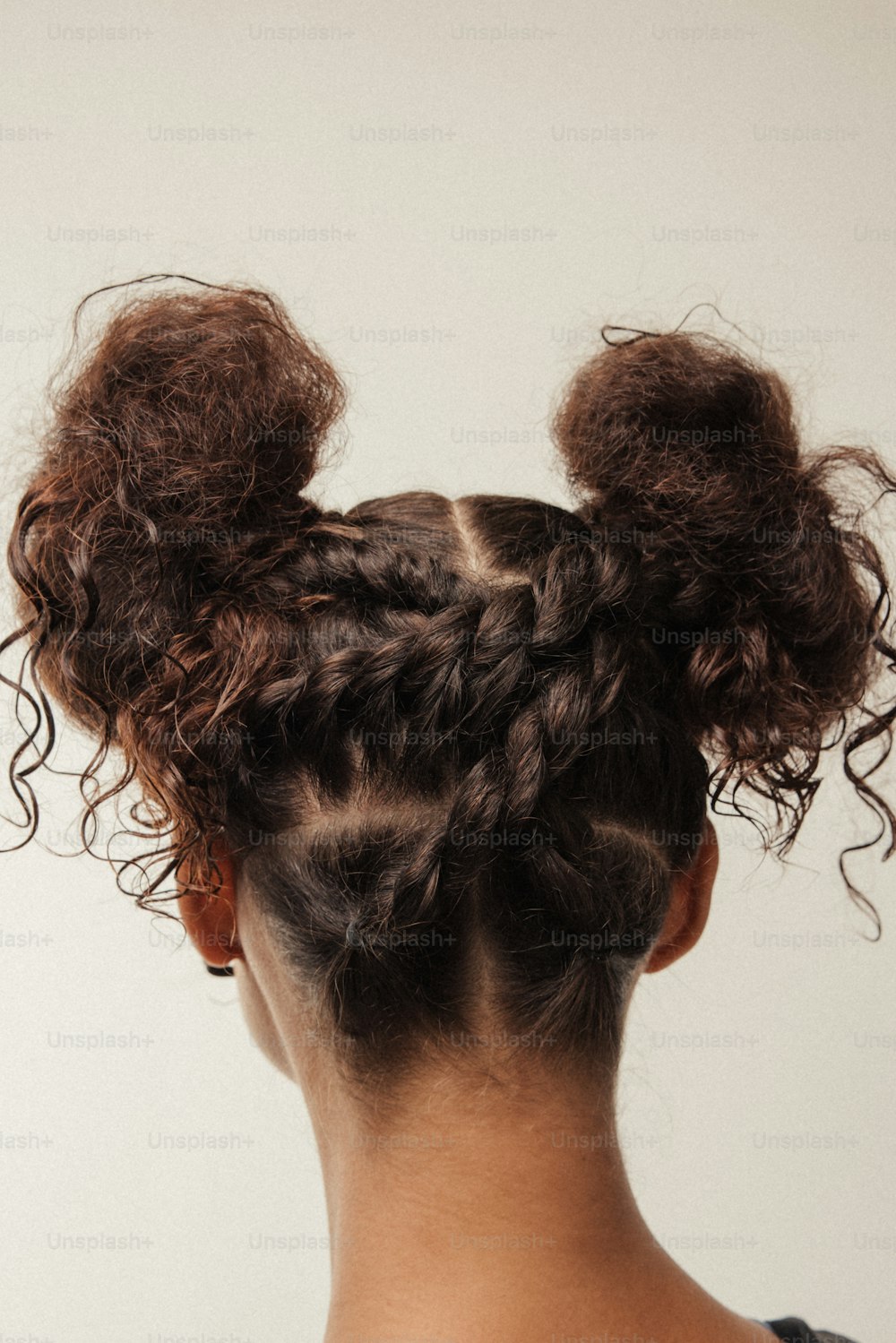 a woman with a messy bun in her hair