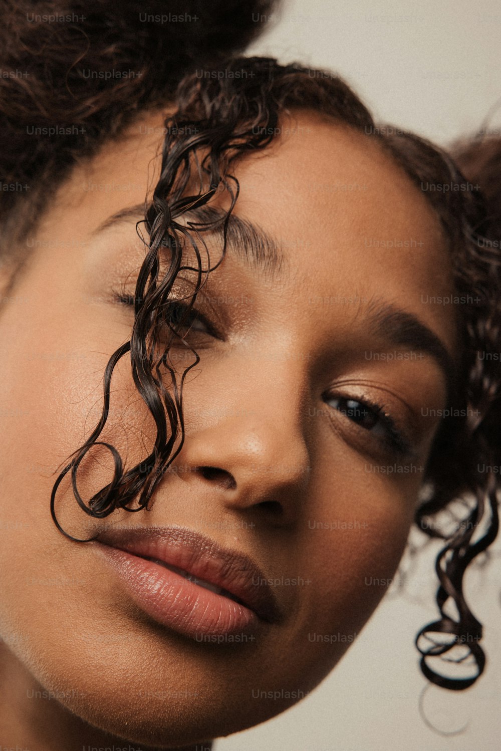 a close up of a woman with curly hair