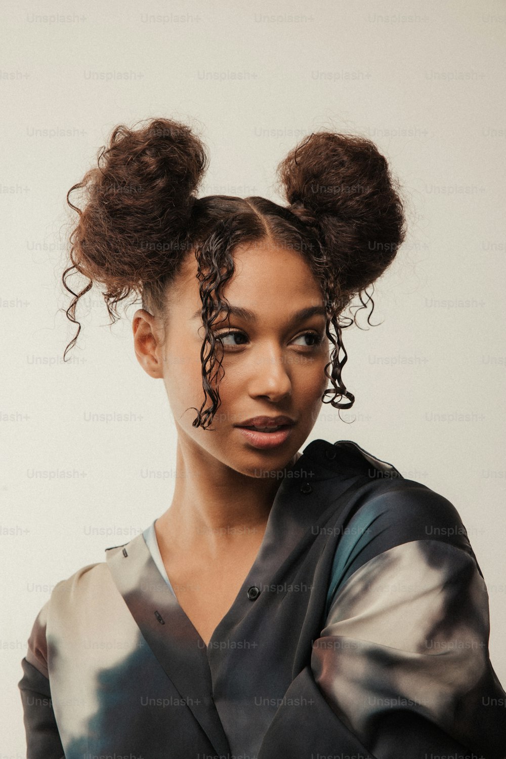 a woman with two hair buns on her head
