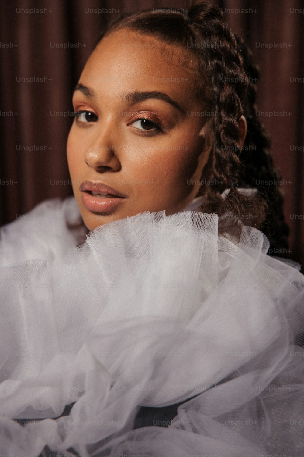 a woman with braids and a white dress