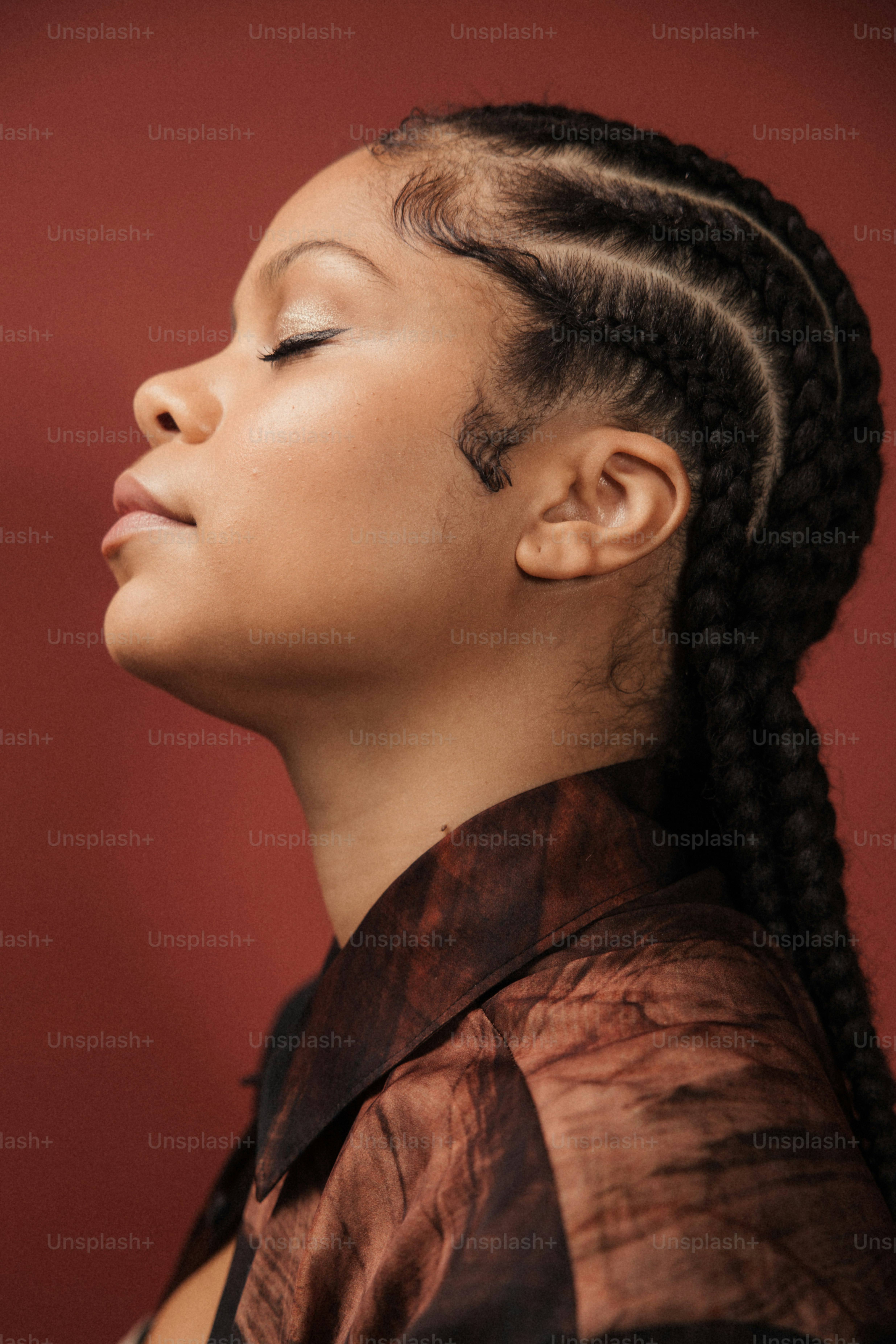 a woman with her eyes closed and her hair in a ponytail