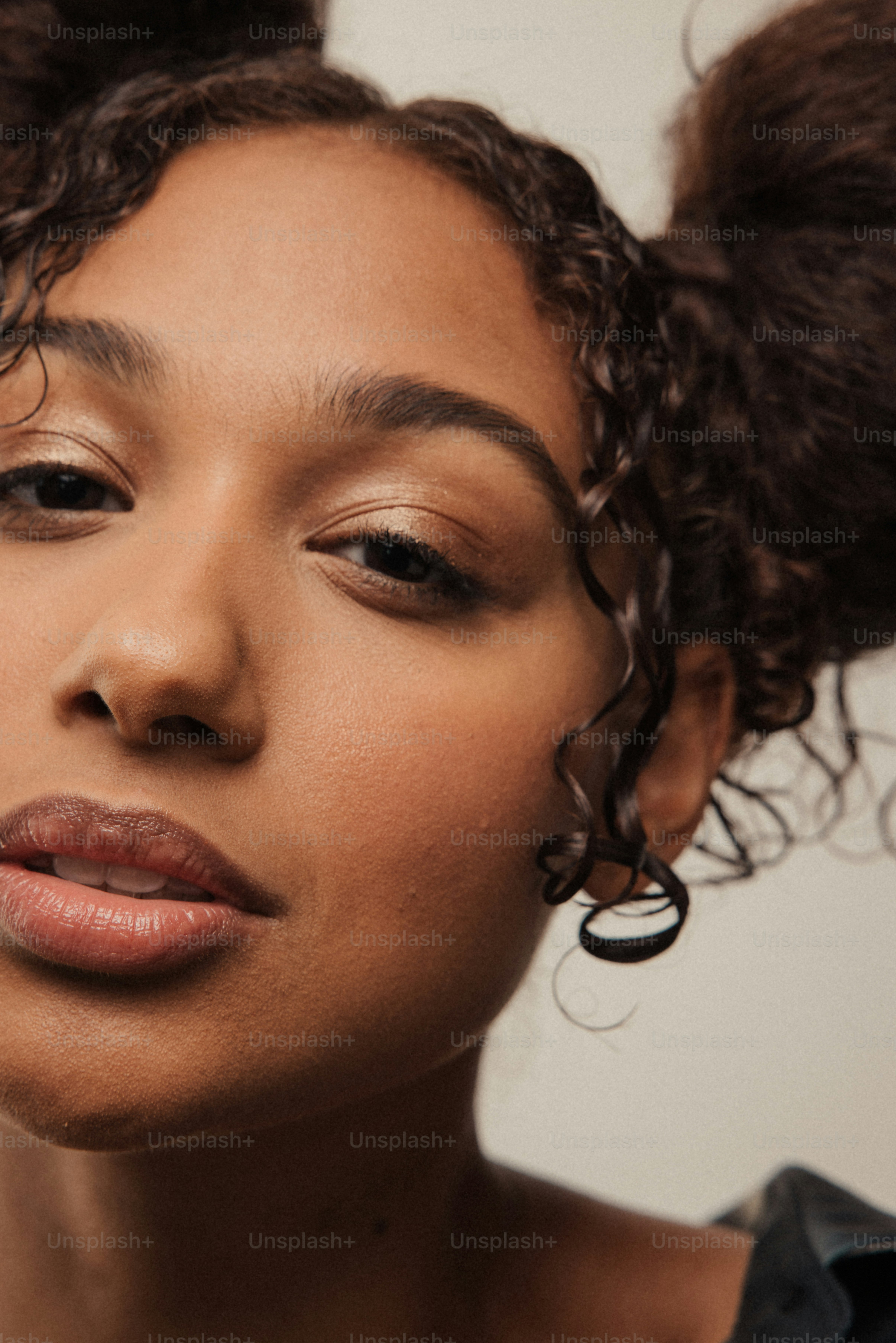 a close up of a person with curly hair