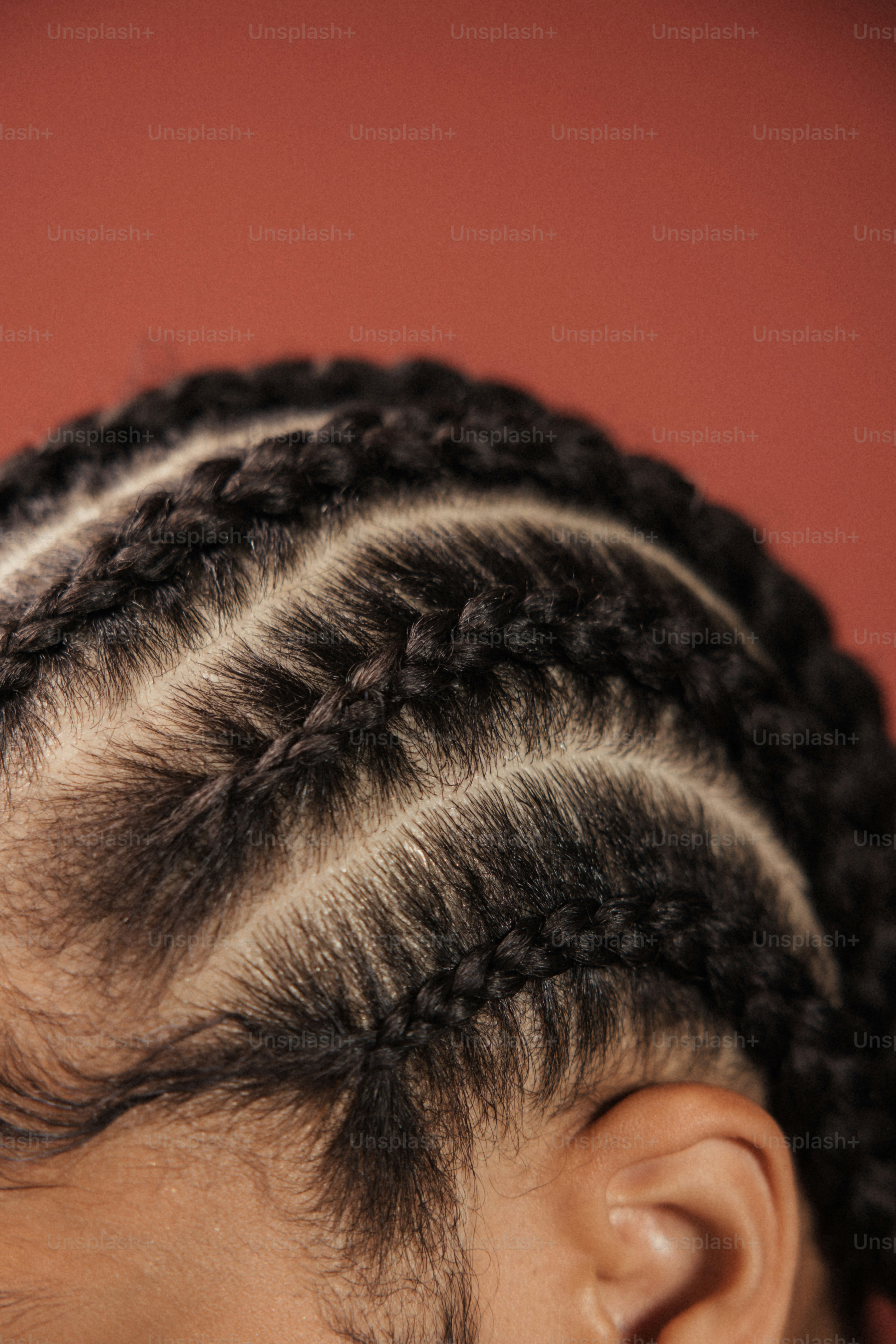 a close up of a child's hair with braids