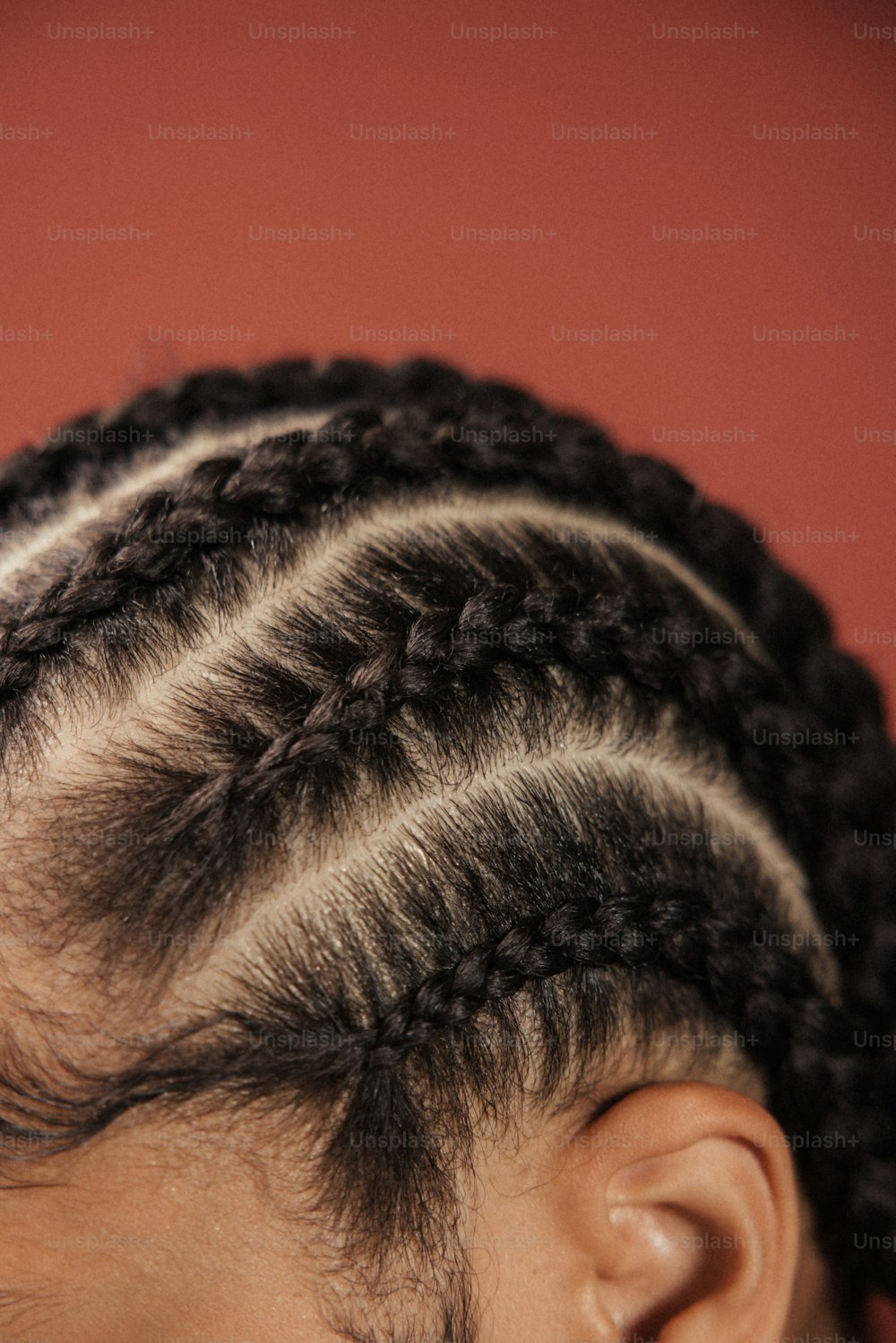 a close up of a child's hair with braids