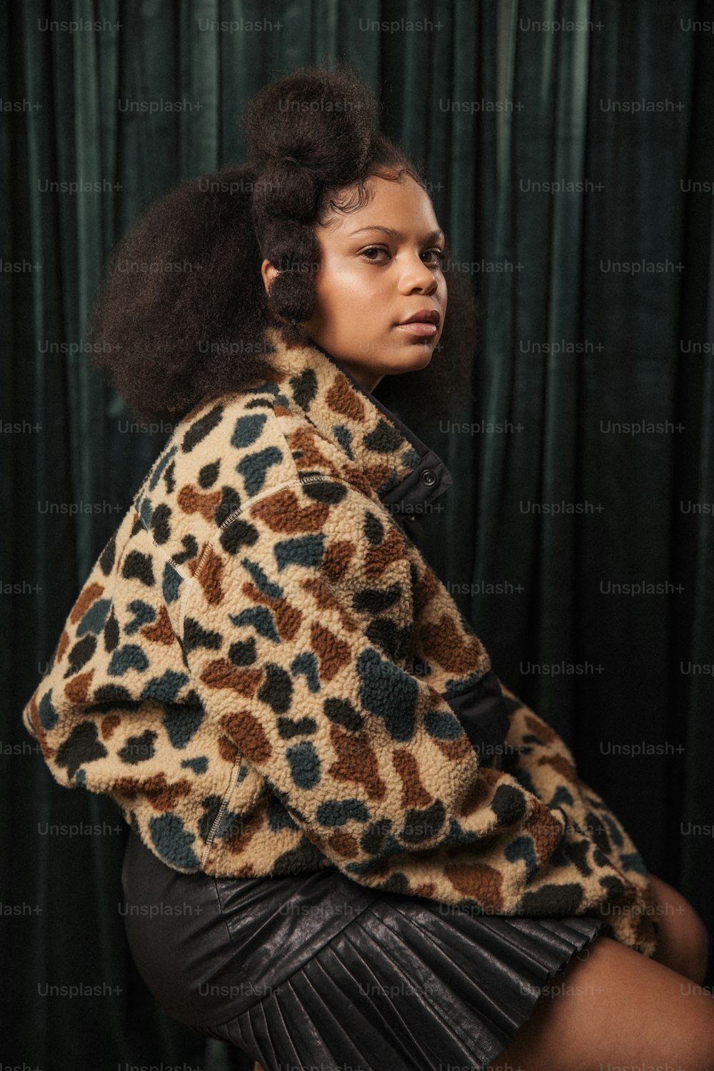 a woman in a leopard print jacket and skirt