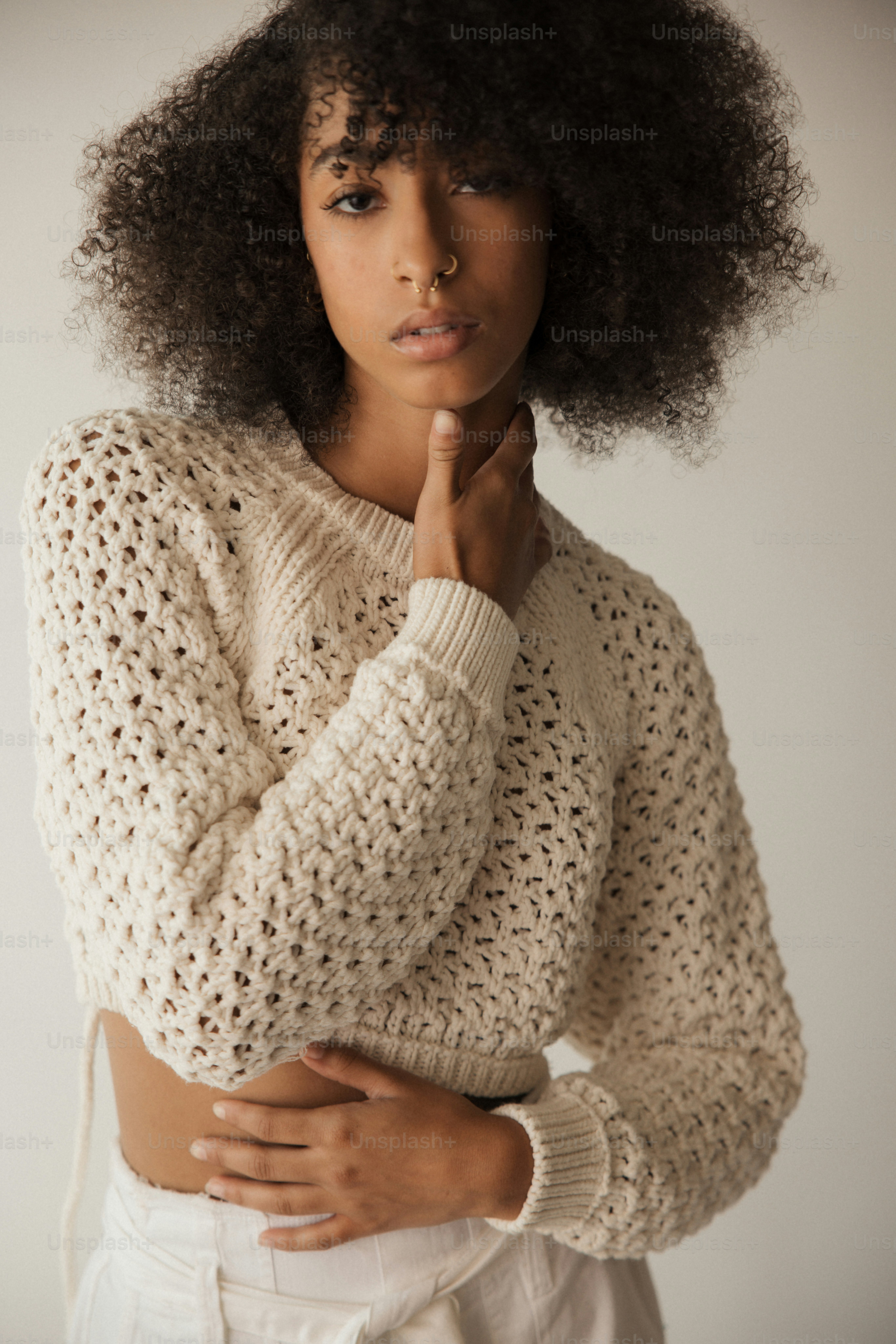 a woman with an afro is posing for a picture