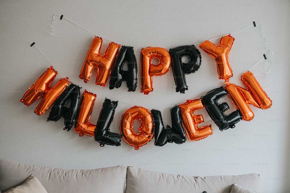 a room with balloons that say happy halloween