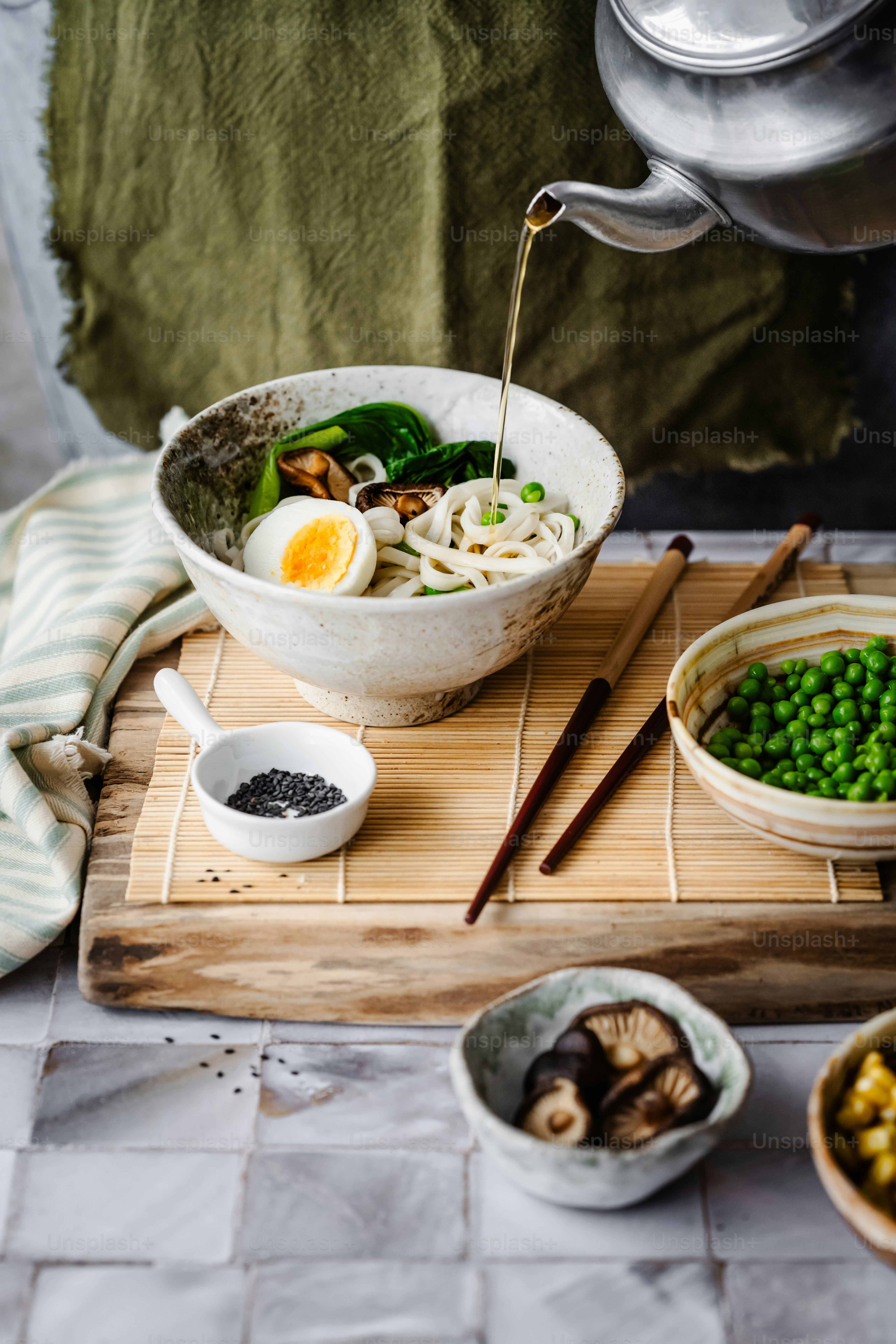 a wooden cutting board topped with bowls of food
