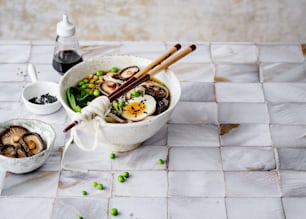 a bowl of food with chopsticks in it